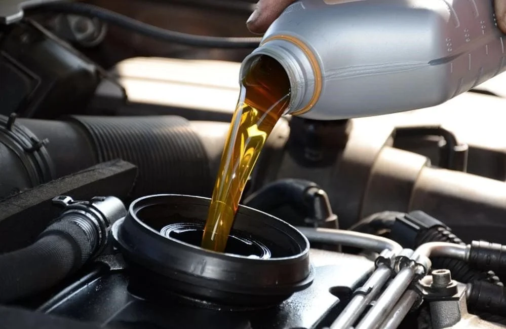 Pouring engine oil into vehicle